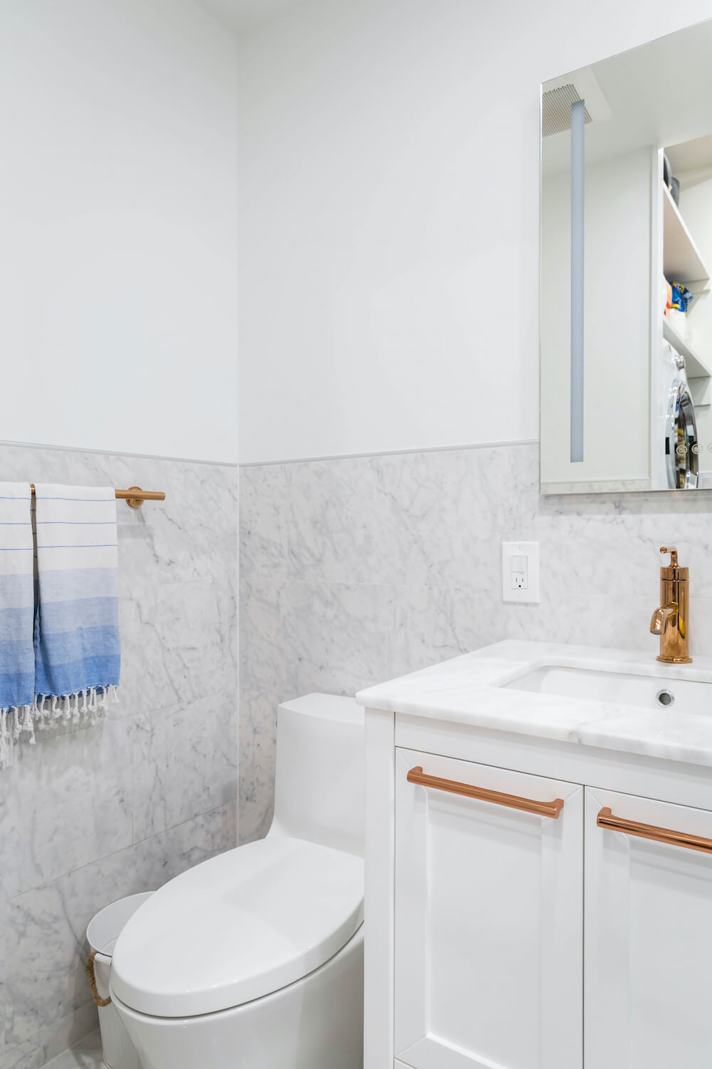 White toilet and vanity with gray calacatta marble