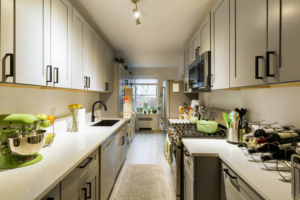 Galley kitchen with gray cabinets and white counters