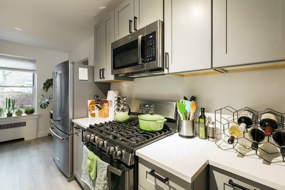 Kitchen with stainless steel appliances and white countertops