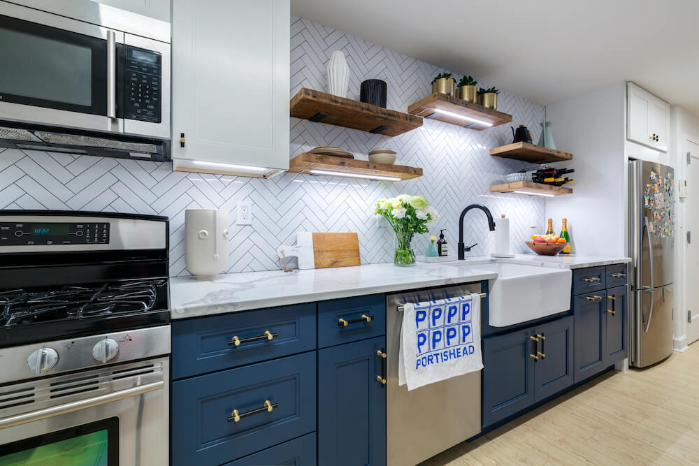 Kitchen with blue cabinets and chevron backsplash
