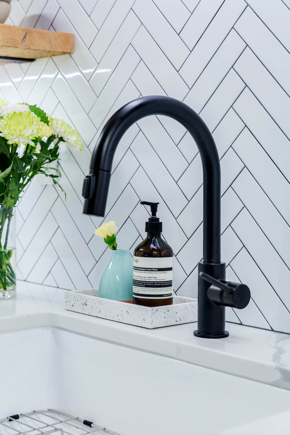 Matte black kitchen faucet and chevron backsplash