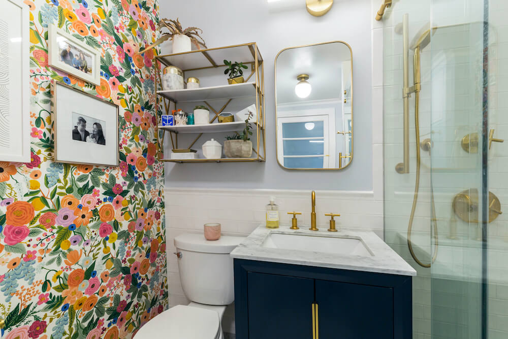 Bathroom with floral wallpaper accent wall