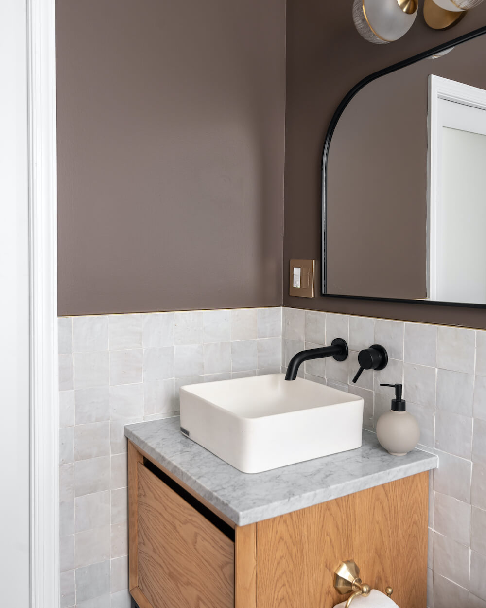 small bathroom remodel in Washington DC with white sink bowl and black wall mount faucet