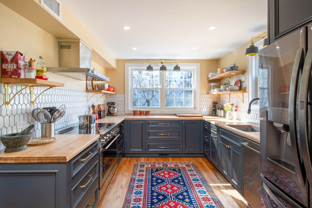kitchen with dark bottom cabinets and hexagon tile backsplash with black grout