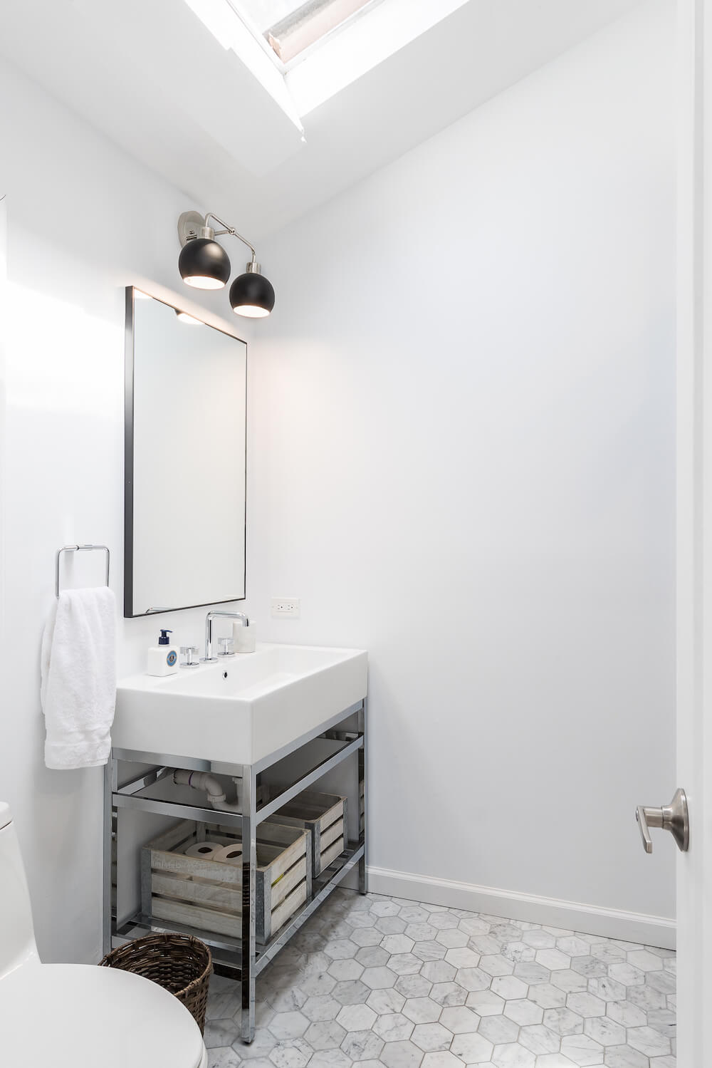 Bathroom with console sink and skylight
