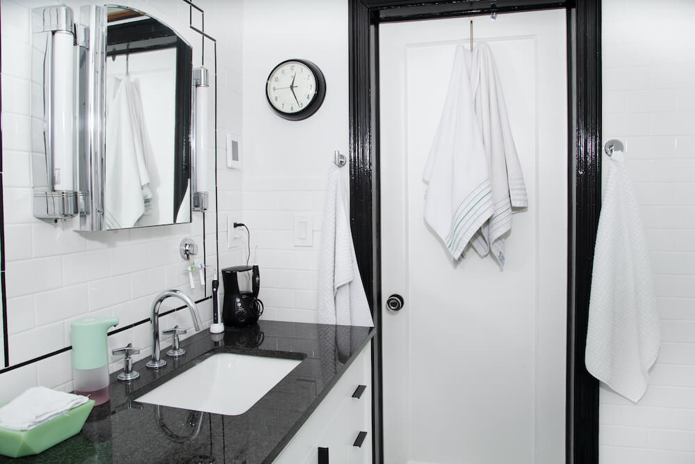 White tiled bathroom with black accents