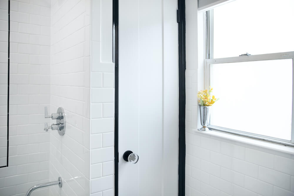 White bathroom closet with black door frame