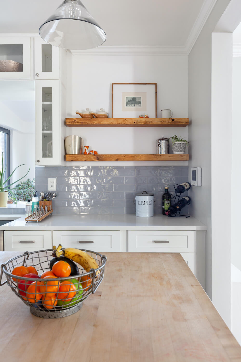 kitchen open shelving with light blue tile backsplash