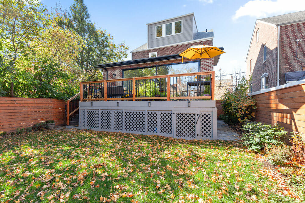 house addition with sunroom and deck