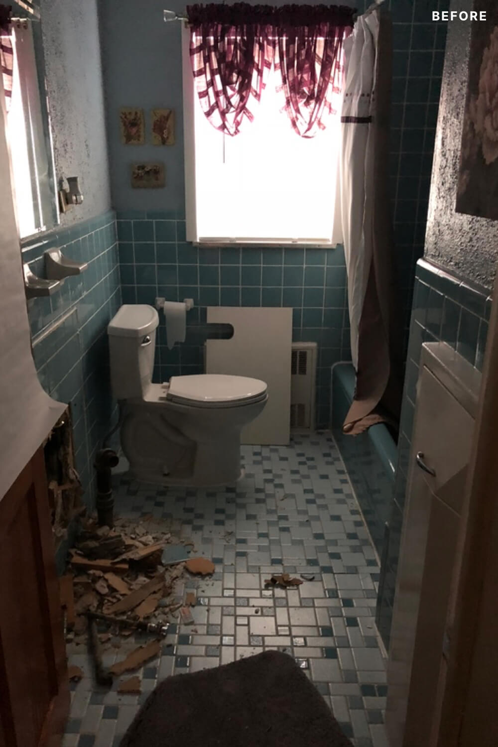 Blue tiled bathroom with gray wall before renovation