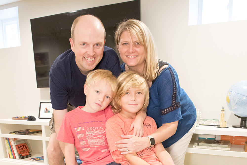 Couple with two kids in the entertainment room after renovation