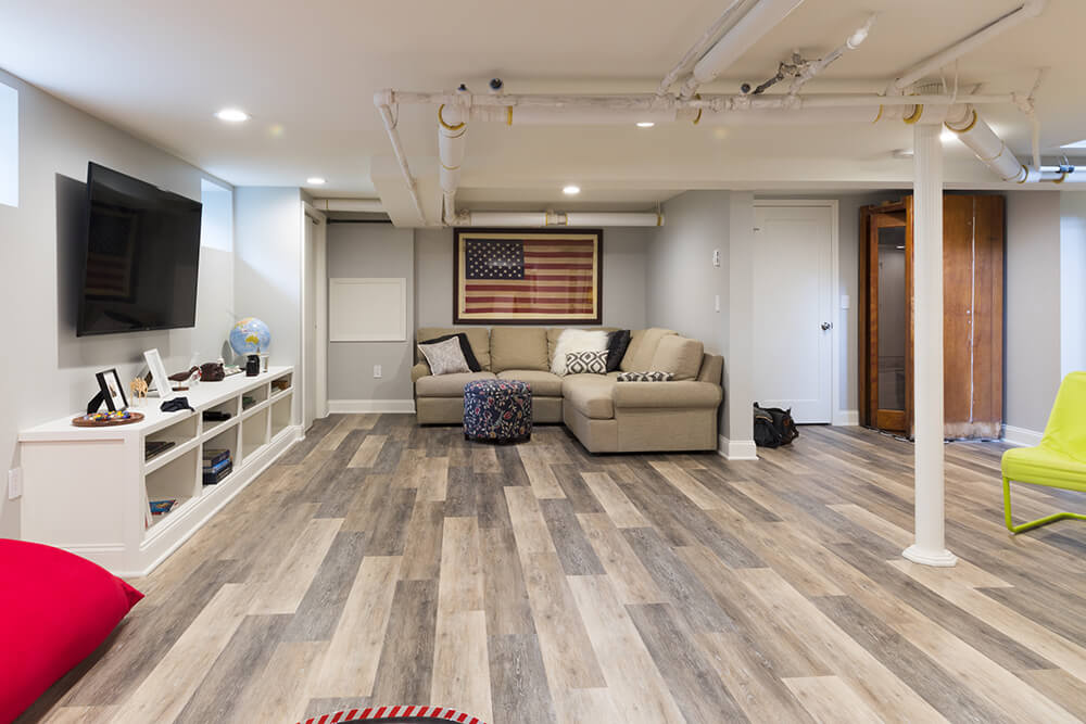 Oak vinyl plank flooring in white entertainment room after renovation