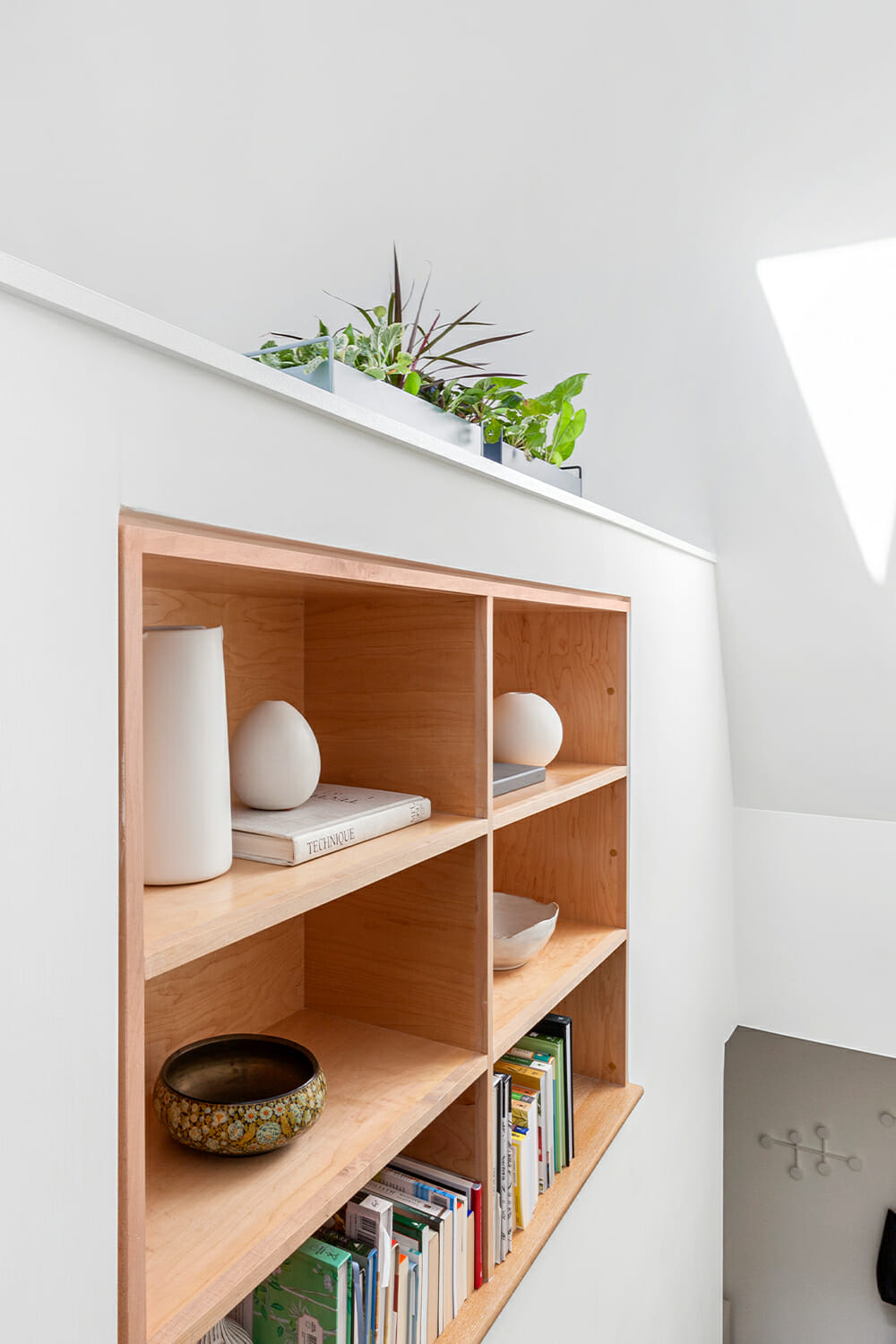 Built in storage shelving alongside the stairway