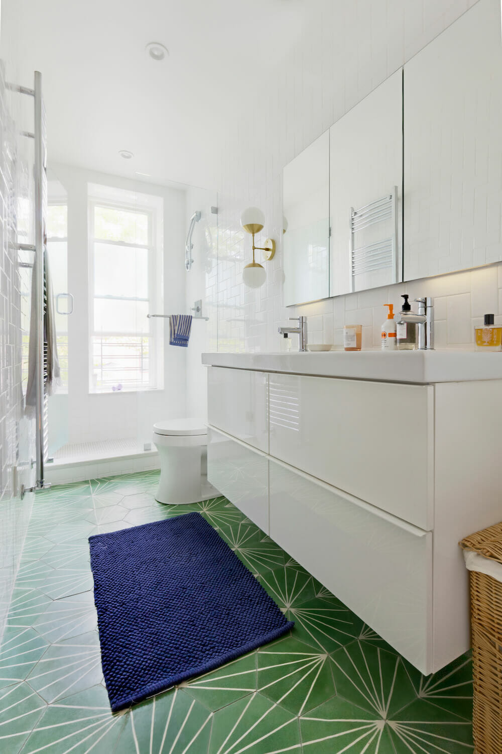 Green hex tiles with sunburst pattern double floating vanity after renovation