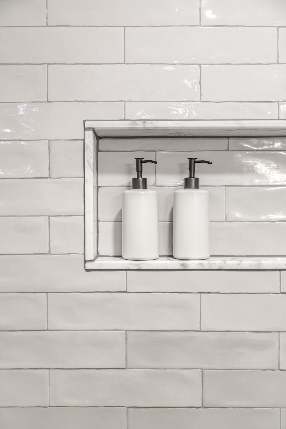 Image of recessed shower niche with white tile