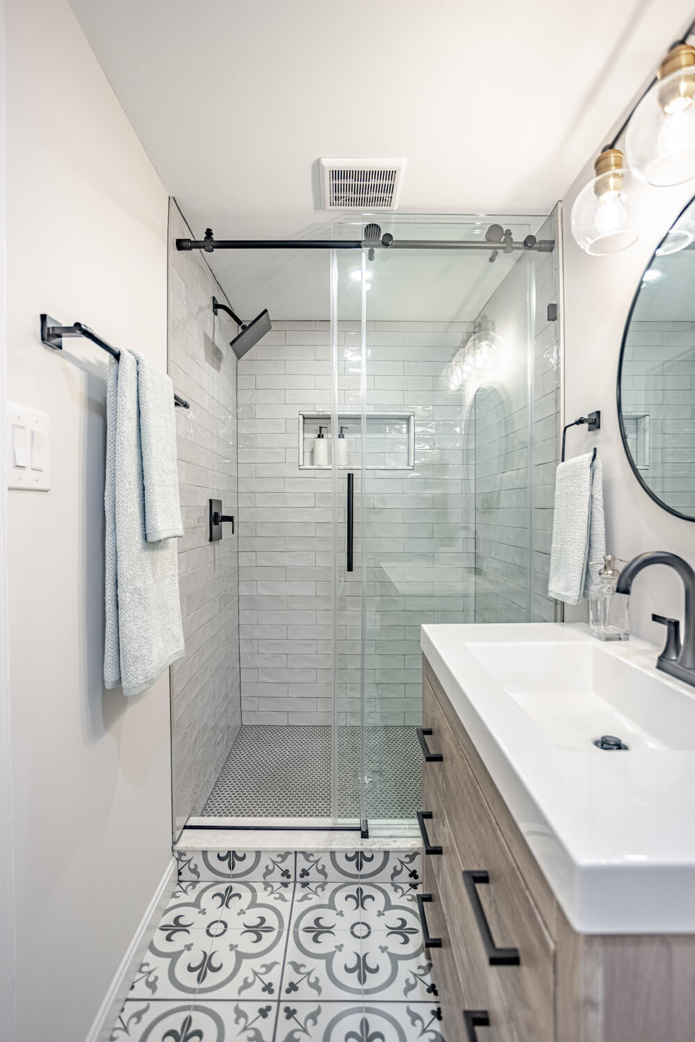 Image of glass shower with gray penny shower tile