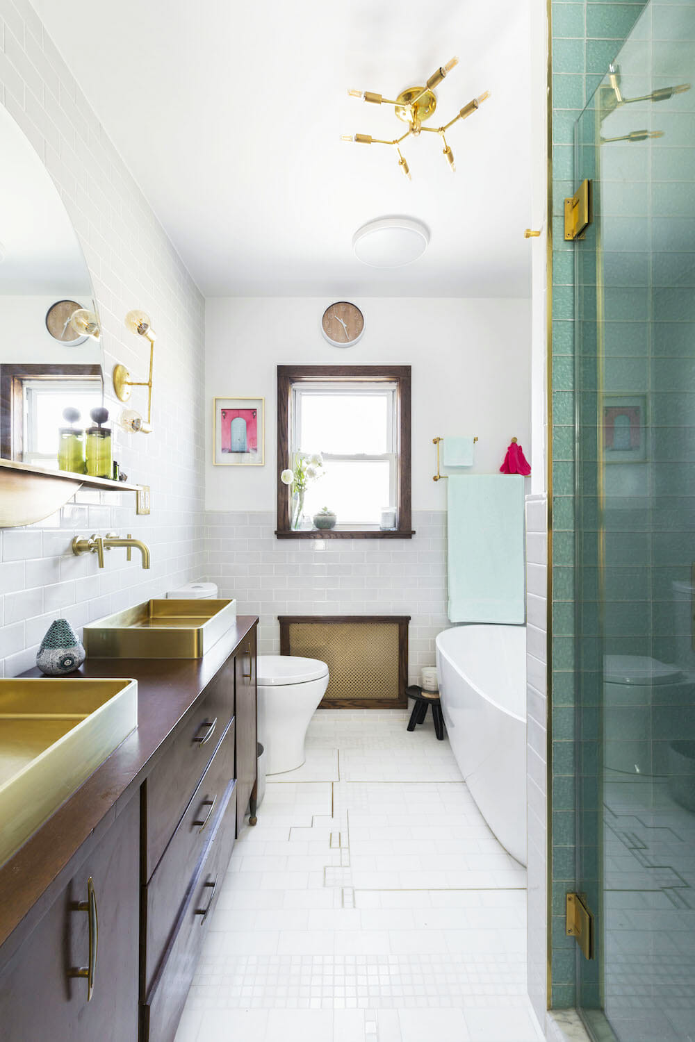 double walnut vanity with gold sink and faucets and fixtures and white tiles on floor and bathroom and walk-in shower after renovation