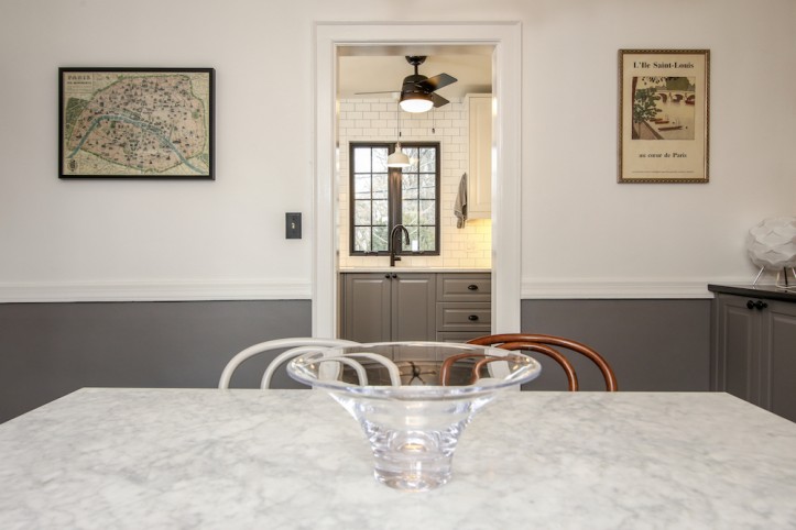 brown half paint wall along with beige in dining room and white marble dining top after renovation