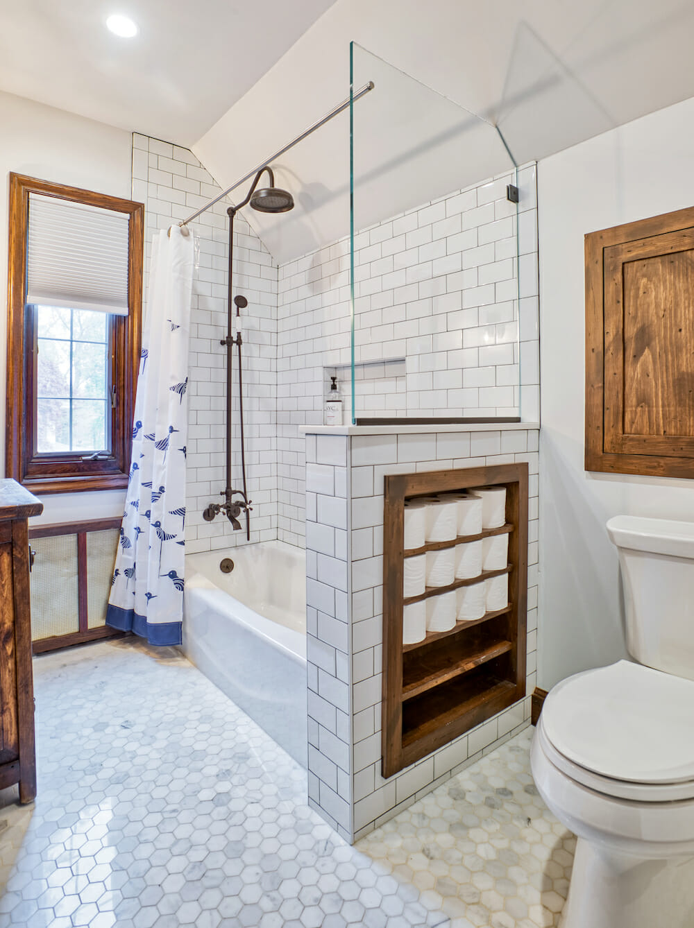 batroom with white walls and bathtub with white subway wall tiles and small hexagon floor tiles after renovation