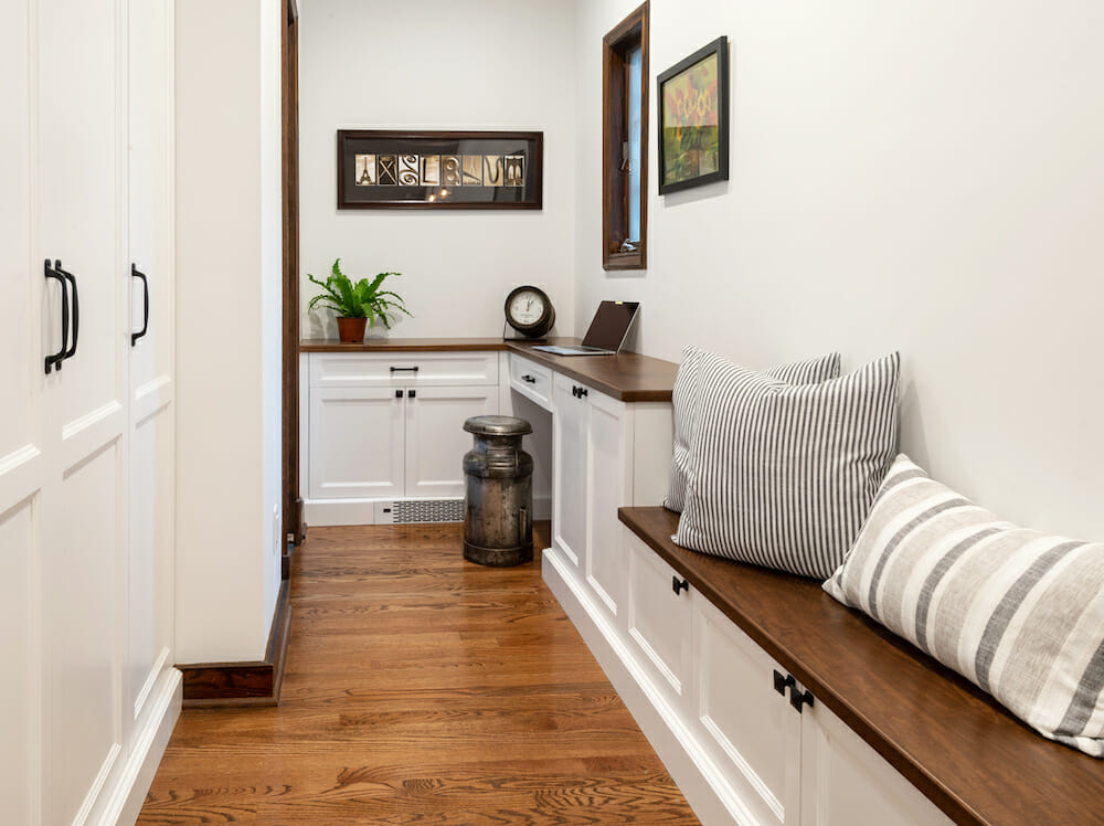 bench with storage cabinets in the hallway and hardwood floors after renovation